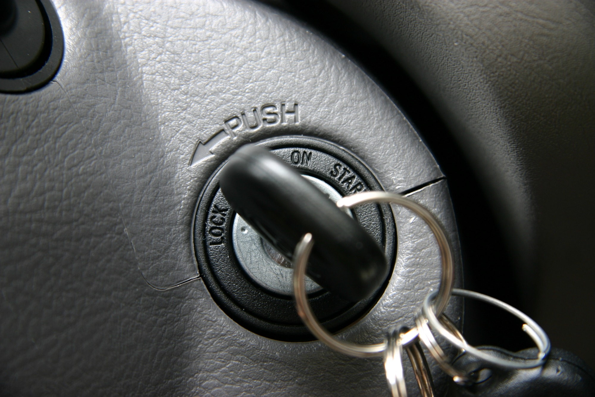 Ignition switch with a key inserted, showing labels for 'LOCK,' 'ON,' and 'START.' The image highlights the mechanism for starting a vehicle.